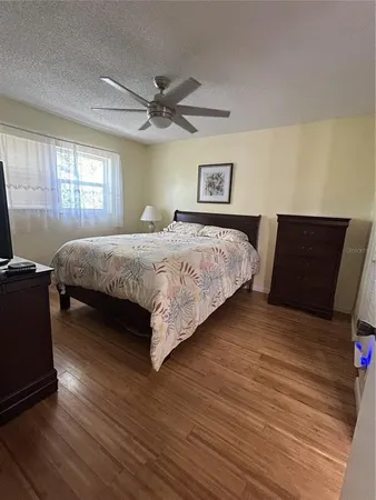 a bedroom with a bed and wooden floor