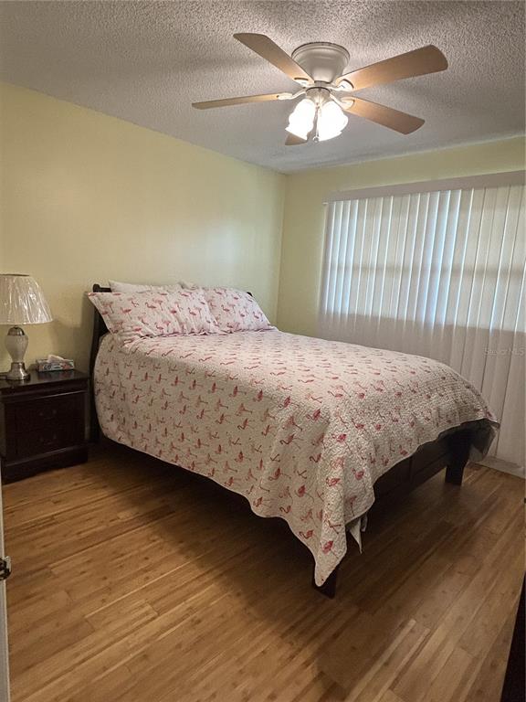11485 Oakhurst Road, Unit 200307 Largo, FL 33774 - Photo 20 of 43 a bedroom with a bed and a chandelier