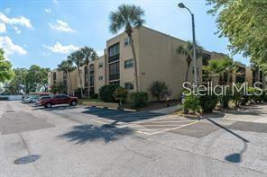 11485 Oakhurst Road, Unit 200307 Largo, FL 33774 - Photo 2 of 43 a couple of cars parked in front of a house