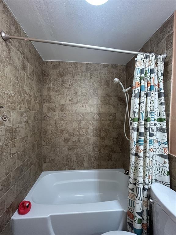 11485 Oakhurst Road, Unit 200307 Largo, FL 33774 - Photo 23 of 43 a bathroom with a shower and a bath tub