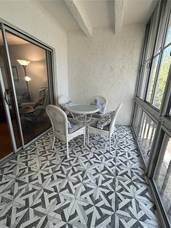 11485 Oakhurst Road, Unit 200307 Largo, FL 33774 - Photo 25 of 43 a living room with a black white checkered floor with a dining table and chair