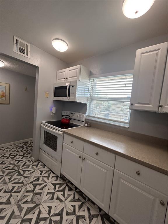 11485 Oakhurst Road, Unit 200307 Largo, FL 33774 - Photo 6 of 43 a kitchen with granite countertop cabinets stainless steel appliances and a sink