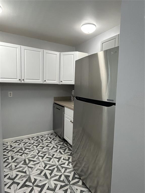 11485 Oakhurst Road, Unit 200307 Largo, FL 33774 - Photo 8 of 43 a kitchen with a refrigerator and cabinets