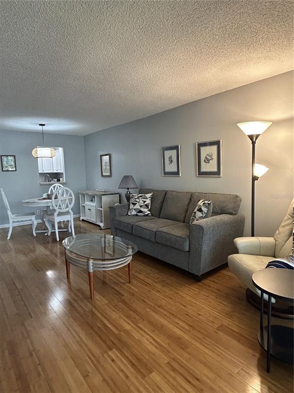 11485 Oakhurst Road, Unit 200307 Largo, FL 33774 - Photo 10 of 43 a living room with furniture and wooden floor