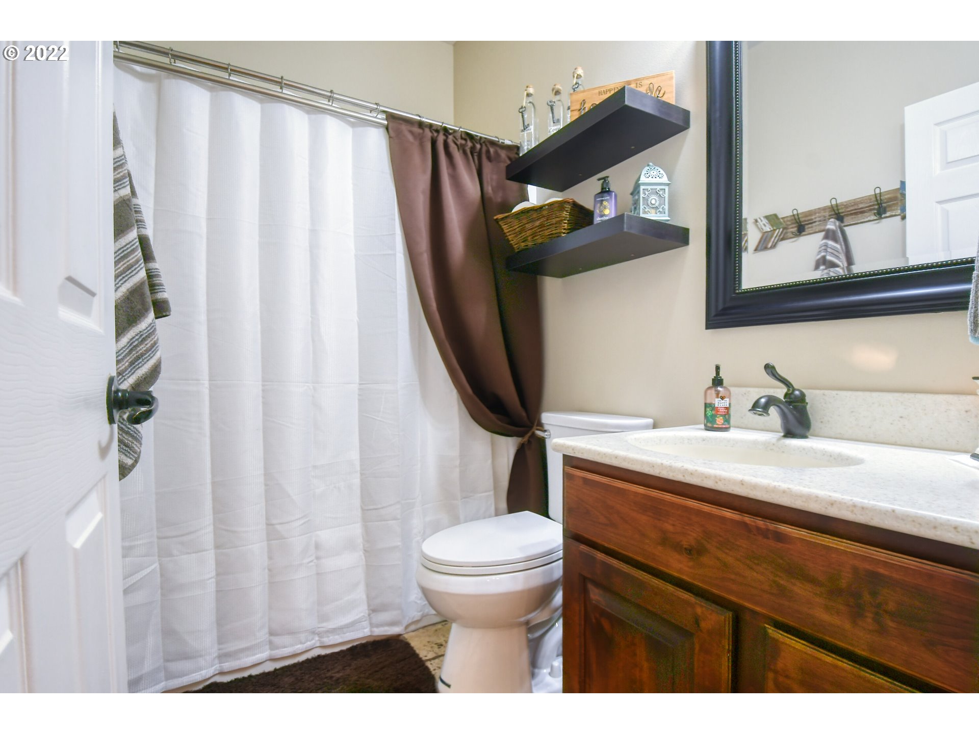 1918 Southwest 1st Street Pendleton, OR 97801 - Photo 21 of 30 a bathroom with a sink a toilet and a mirror
