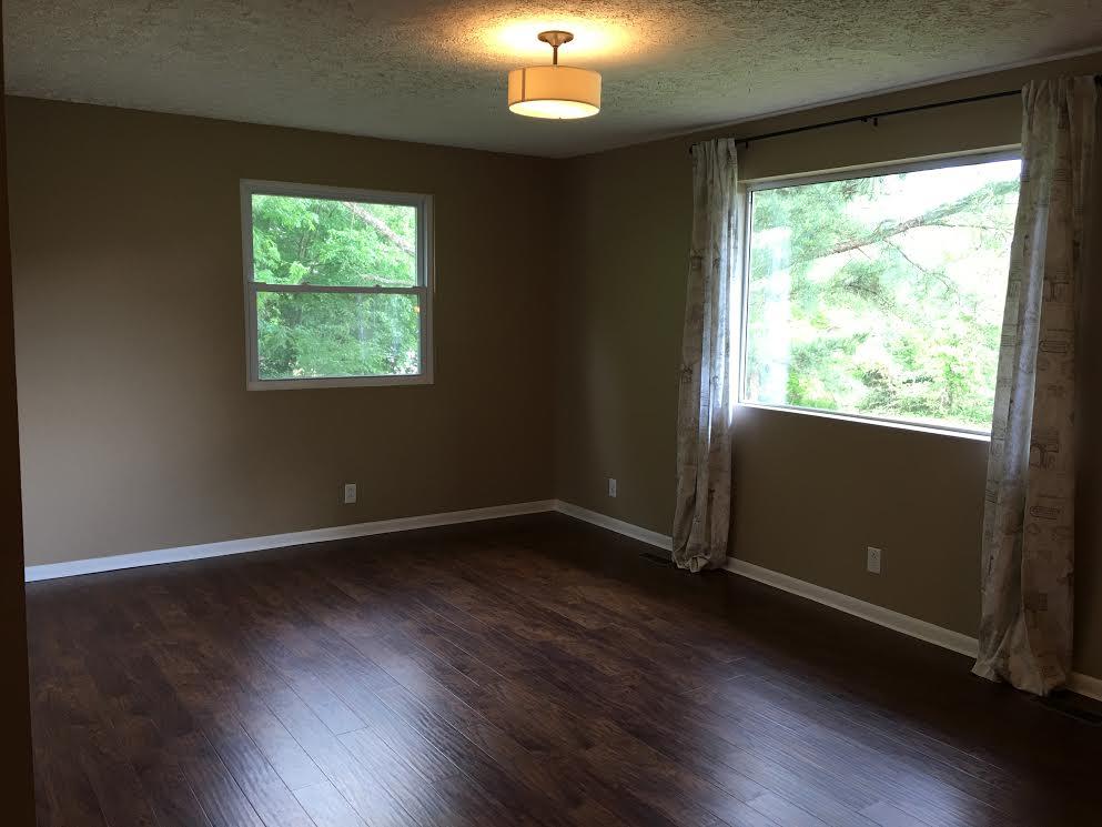 6056 Highway 76 East Springfield, TN 37172 - Photo 3 of 21 an empty room with wooden floor and windows