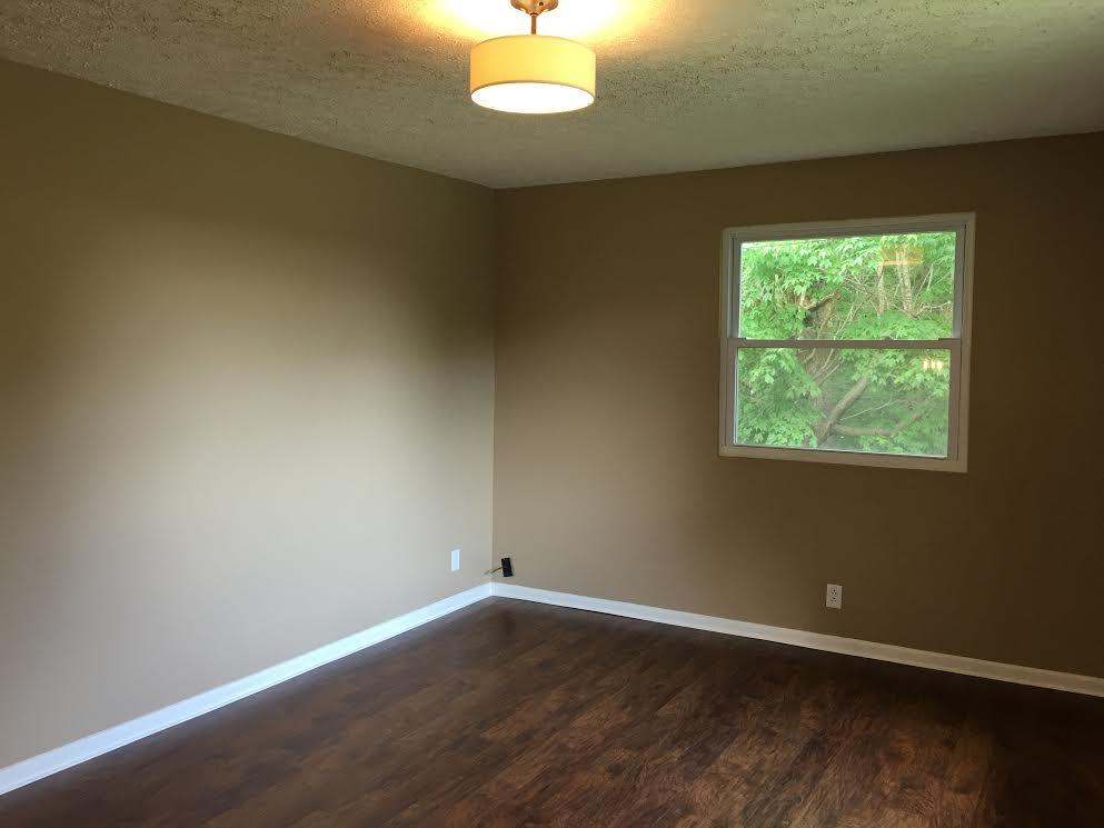 6056 Highway 76 East Springfield, TN 37172 - Photo 4 of 21 a view of an empty room with wooden floor and a window