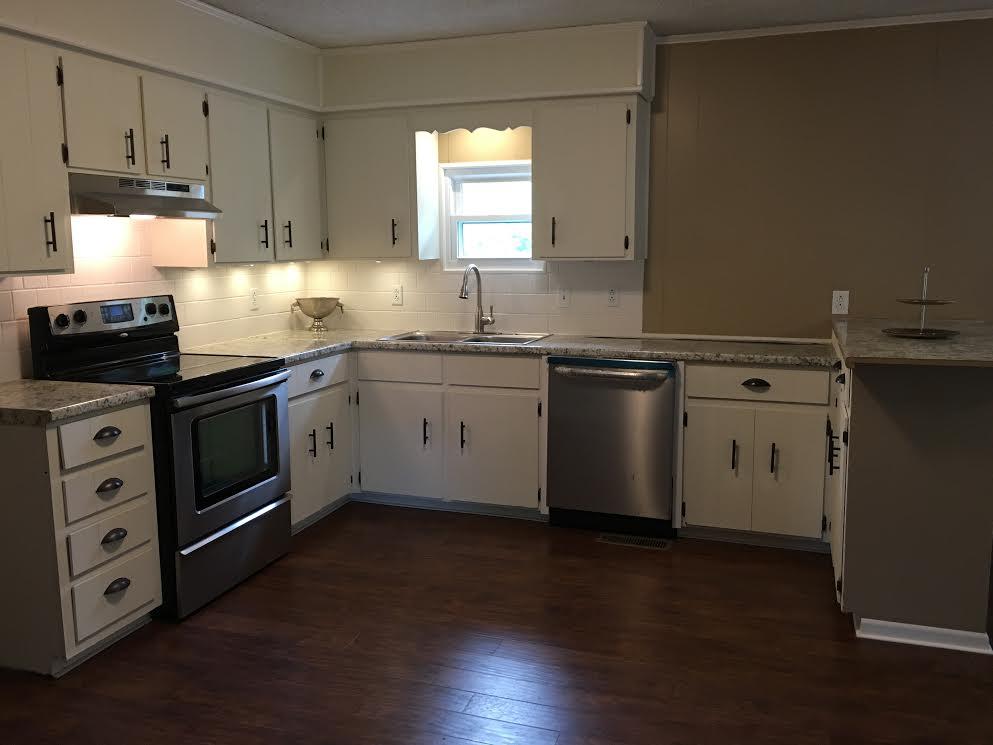 6056 Highway 76 East Springfield, TN 37172 - Photo 6 of 21 a kitchen with stainless steel appliances granite countertop a stove a sink and a microwave
