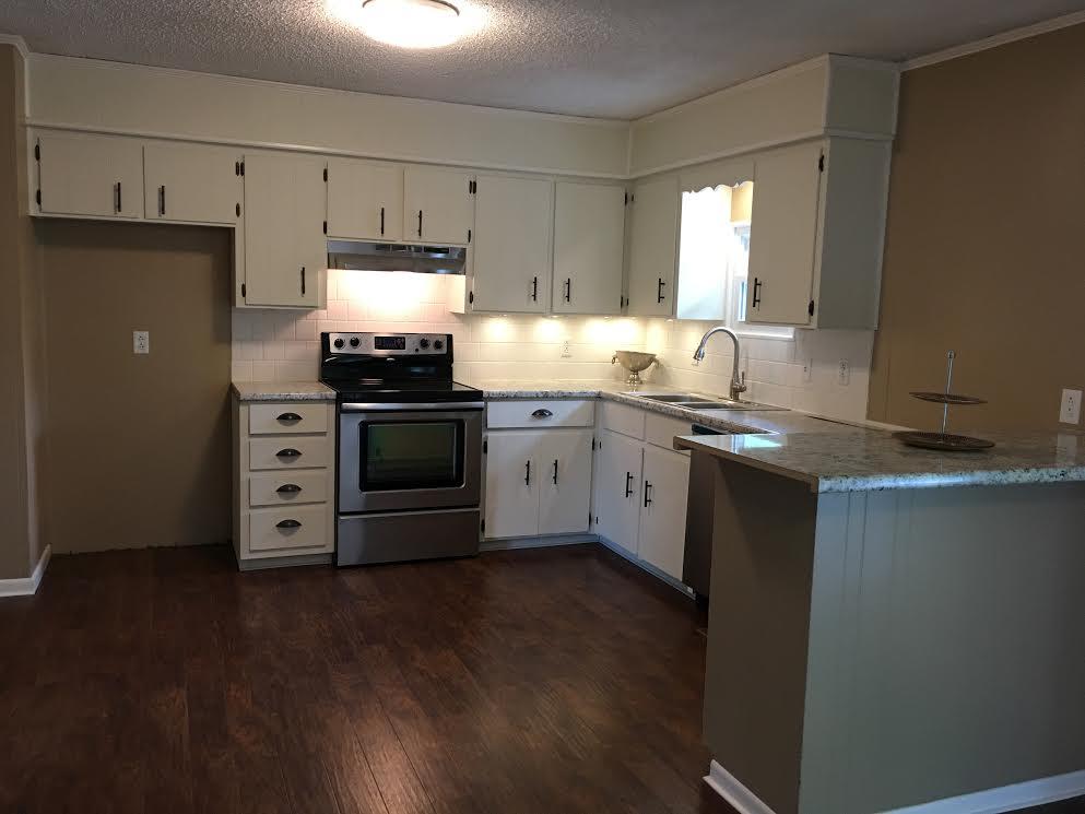 6056 Highway 76 East Springfield, TN 37172 - Photo 7 of 21 a kitchen with stainless steel appliances granite countertop a stove a sink and a microwave