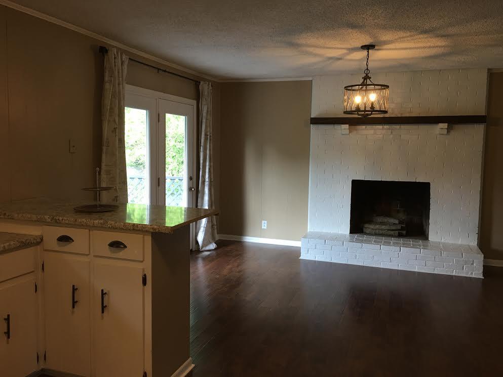 6056 Highway 76 East Springfield, TN 37172 - Photo 8 of 21 a view of an empty room with wooden floor and a fireplace