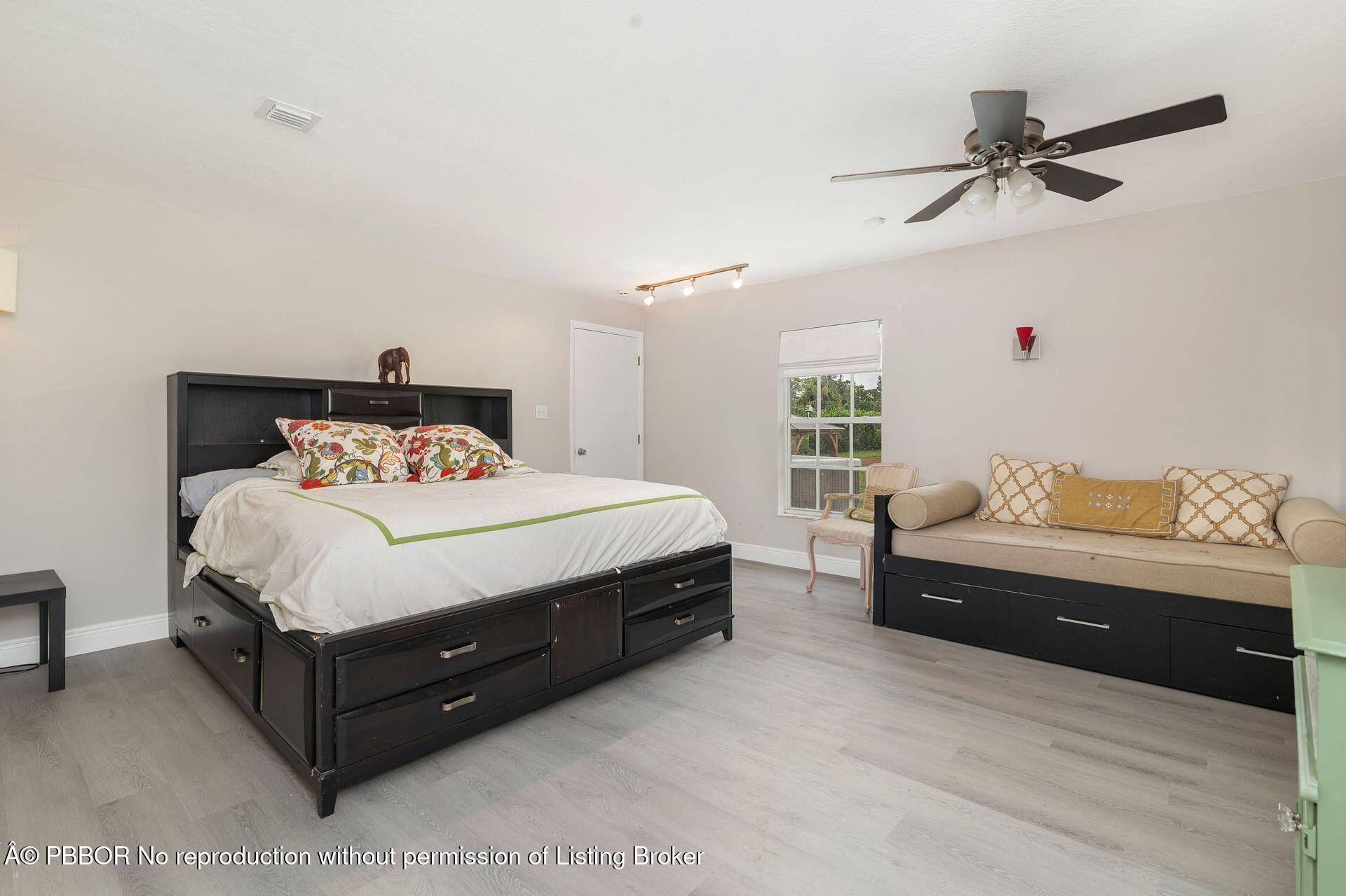 2770 E Road Loxahatchee, FL 33470 - Photo 23 of 51 a bedroom with a bed and window