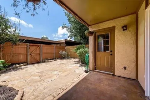 a view of backyard with a large tree