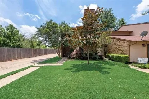 a view of a backyard with table and chairs and wooden fence