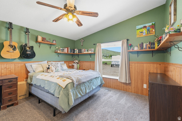 8066 North Valley View Heights Preston, ID 83263 - Photo 24 of 34 Bedroom featuring vaulted ceilings, wood-panel wainscoting, and carpet flooring