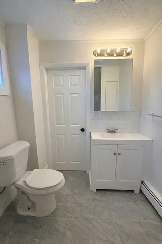 a white toilet sitting next to a bathroom sink