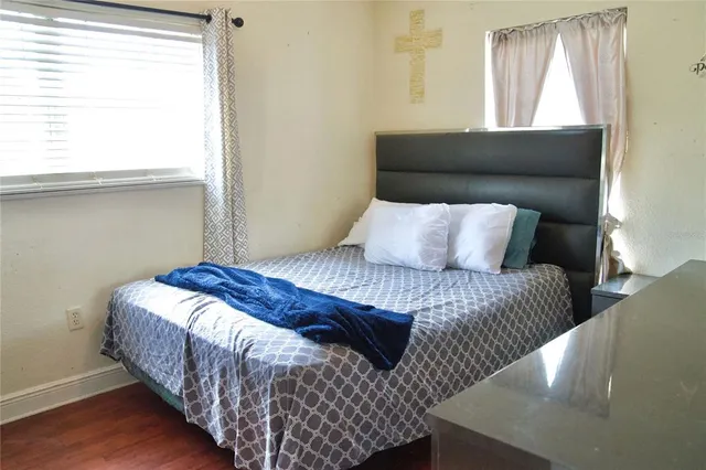 a bedroom with a bed and window