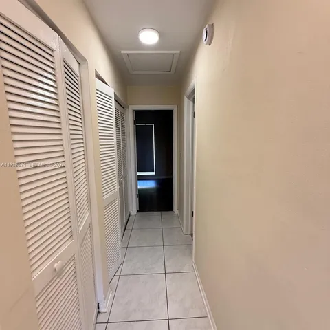 a view of a hallway and a livingroom with a hallway