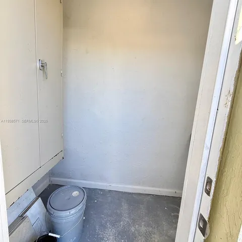 a bathroom with a granite countertop toilet and a sink
