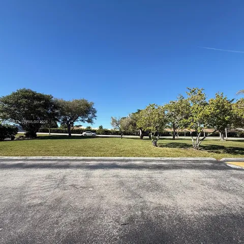 a view of swimming pool with outdoor space and trees in the background