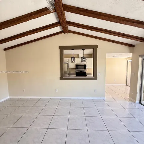 a view of an empty room and a window