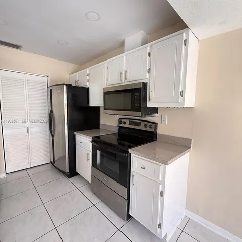 a kitchen with a stove microwave and refrigerator