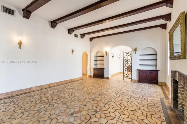 a view of empty room with a fireplace