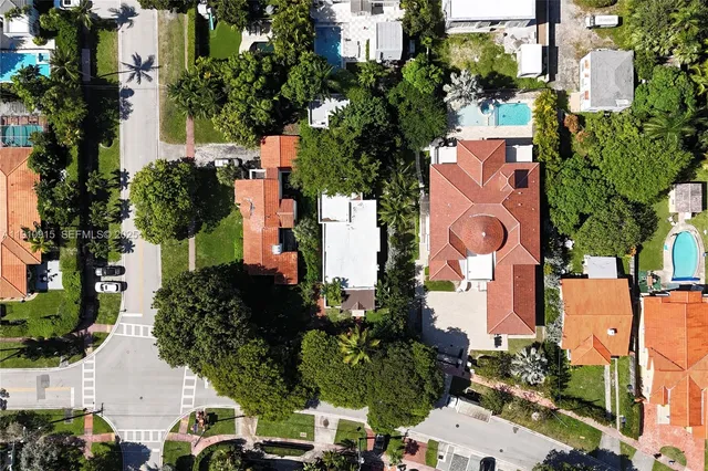an aerial view of residential houses with outdoor space and street view