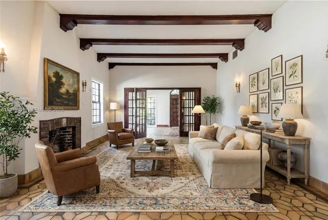 a living room with furniture a fireplace and a flat screen tv