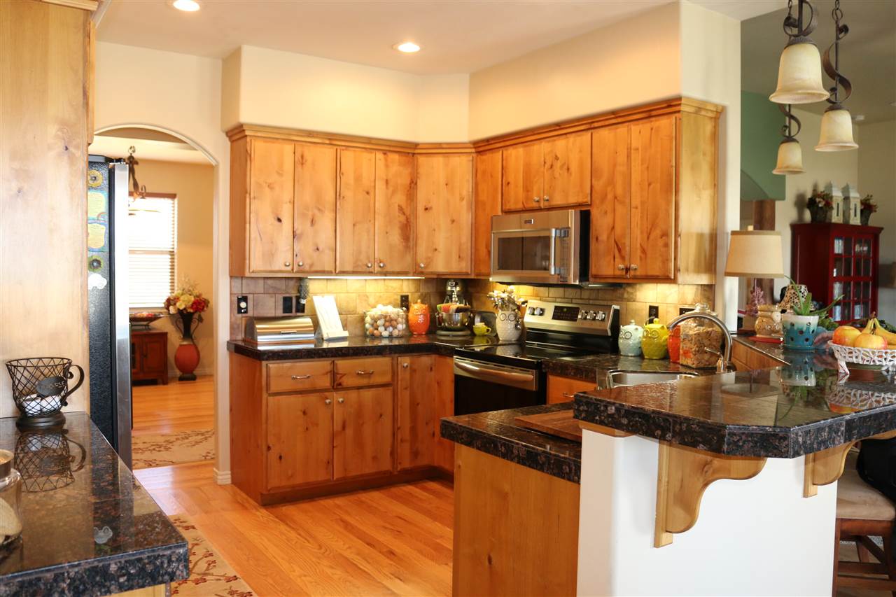 755 R Road Mack, CO 81525 - Photo 5 of 41 a kitchen with stainless steel appliances granite countertop a stove a sink and a microwave