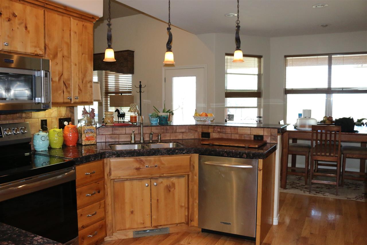 755 R Road Mack, CO 81525 - Photo 7 of 41 a kitchen with stainless steel appliances granite countertop a stove a sink and a microwave