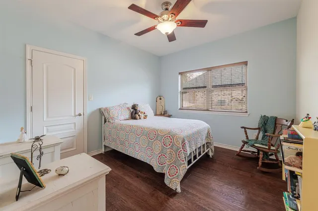 a bedroom with a bed and a desk