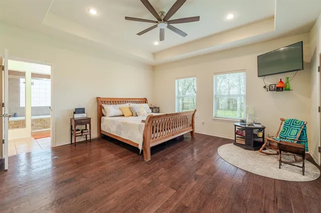 a bedroom with a bed and a flat screen tv