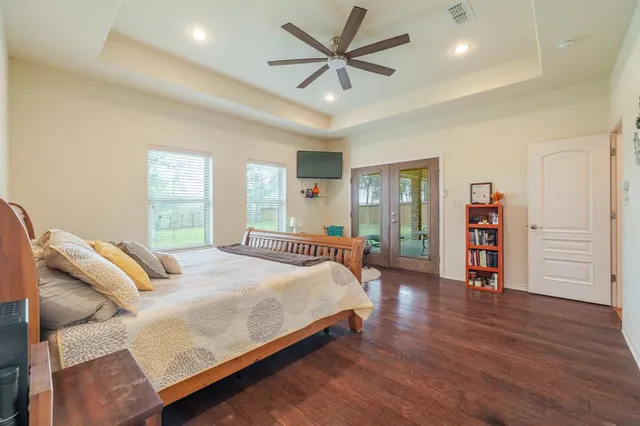 a bedroom with a bed and a wooden floor