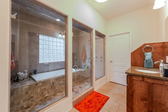 a bathroom with a tub sink and a window