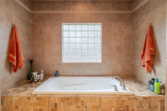 a bath tub sitting next to a window