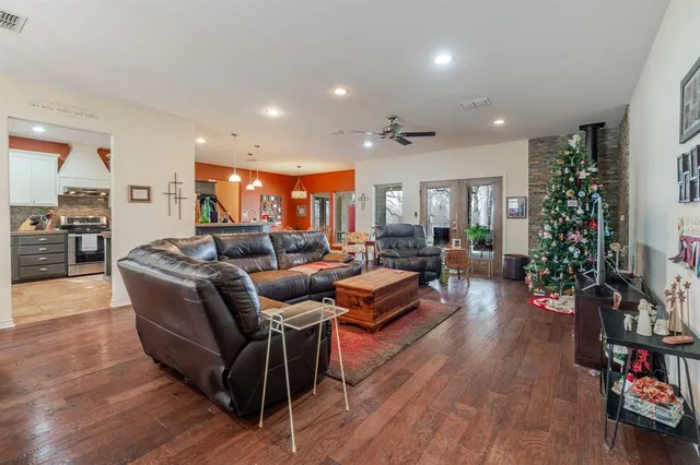 a living room with furniture and a wooden floor