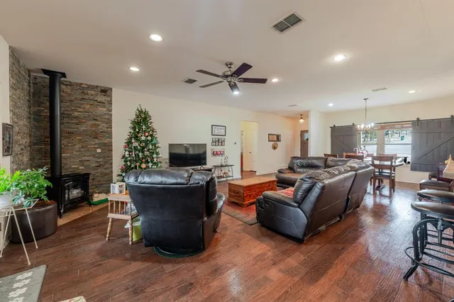 a living room with furniture a fireplace and a potted plant