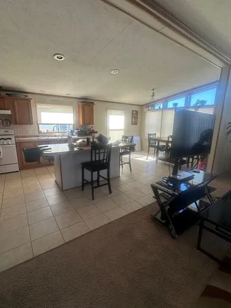 a living room with furniture a large window and a table