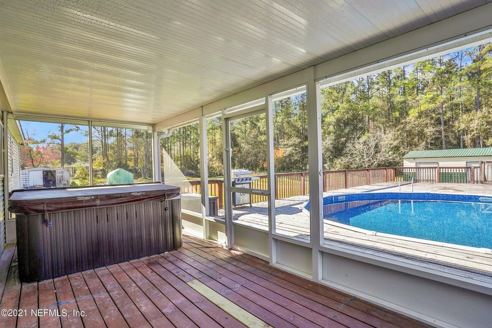54445 Lawhon Road West Callahan, FL 32011 - Photo 2 of 6 a view of a large pool with wooden floor and outdoor space