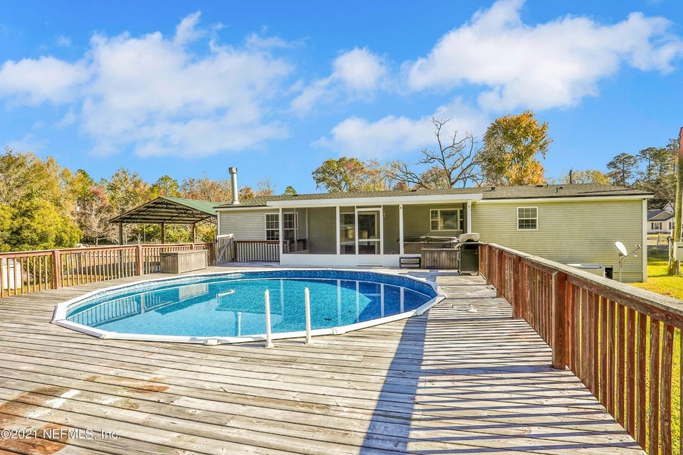 54445 Lawhon Road West Callahan, FL 32011 - Photo 3 of 6 a view of a house with swimming pool and sitting area