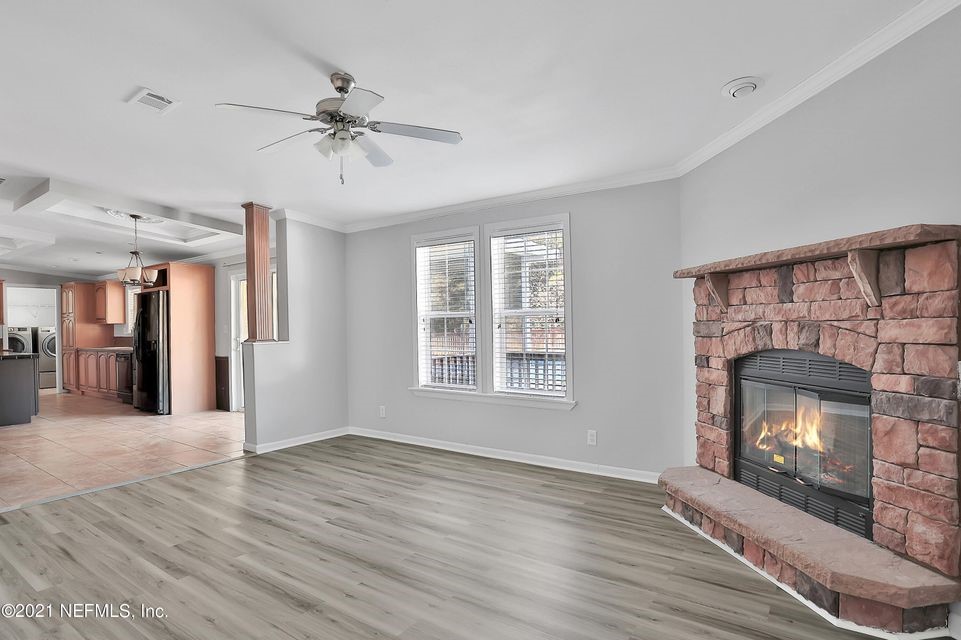 54445 Lawhon Road West Callahan, FL 32011 - Photo 6 of 6 a view of an empty room with wooden floor fireplace and a window