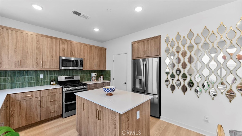 104 Lipizzan Lane Fallbrook, CA 92028 - Photo 11 of 53 a kitchen that has a sink a stove top oven a refrigerator and cabinets