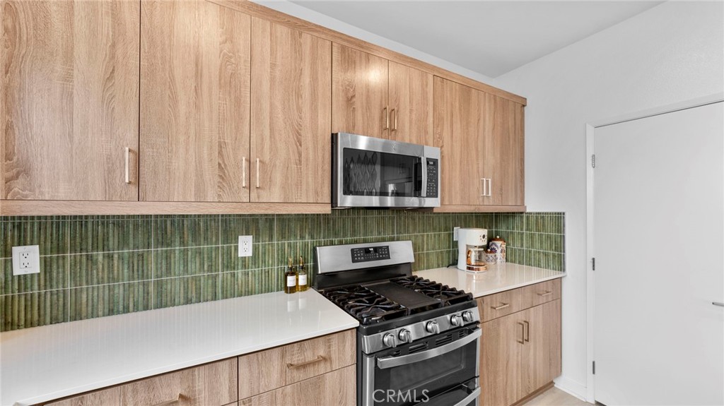 104 Lipizzan Lane Fallbrook, CA 92028 - Photo 12 of 53 a kitchen with wooden cabinets and a stove top oven