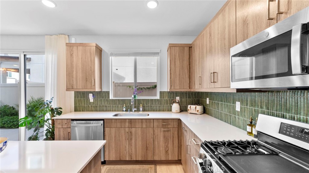 104 Lipizzan Lane Fallbrook, CA 92028 - Photo 13 of 53 a kitchen with a sink stove and cabinets