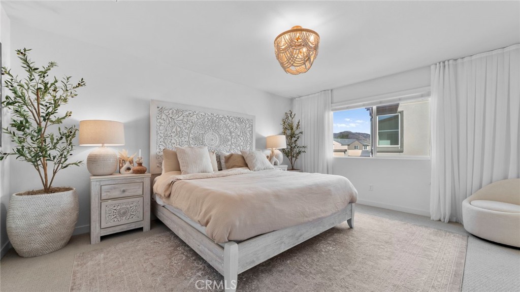 104 Lipizzan Lane Fallbrook, CA 92028 - Photo 19 of 53 a bedroom with bed and a potted plant