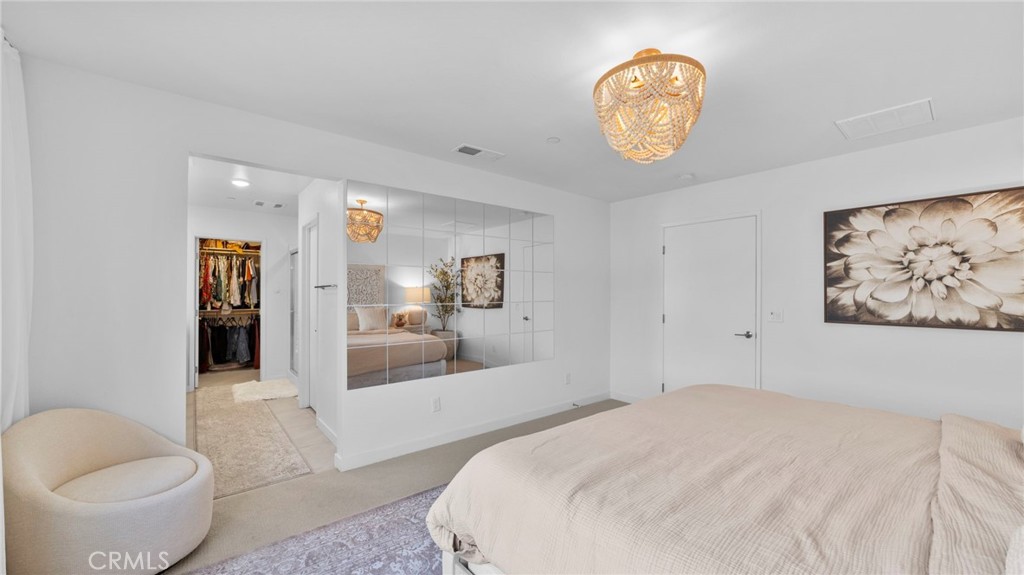 104 Lipizzan Lane Fallbrook, CA 92028 - Photo 20 of 53 a spacious bedroom with a bed and a large mirror