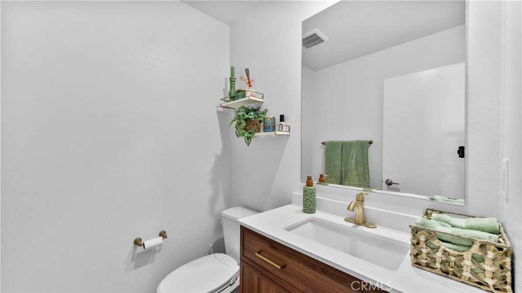 104 Lipizzan Lane Fallbrook, CA 92028 - Photo 25 of 53 a bathroom with a sink toilet and mirror