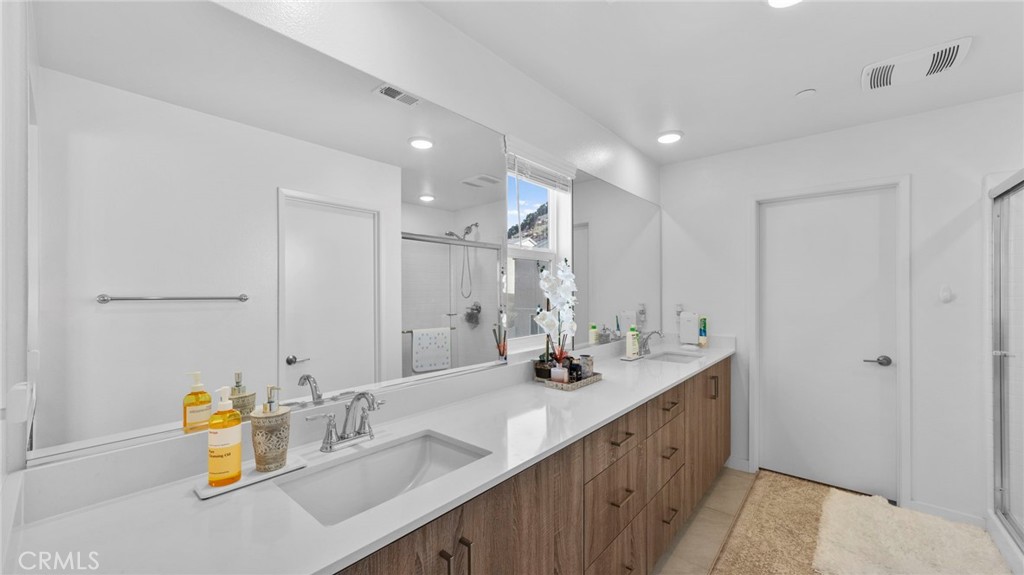 104 Lipizzan Lane Fallbrook, CA 92028 - Photo 28 of 53 a bathroom with a double vanity sink and a mirror