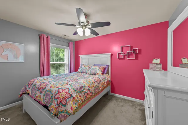a bedroom with a bed and a view of kitchen