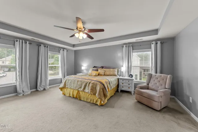a bedroom with bed and a chandelier